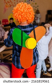 A Children's Animator In A Carlson Costume With A Propeller Indoors Entertains Children In A Kindergarten At A Birthday Party.