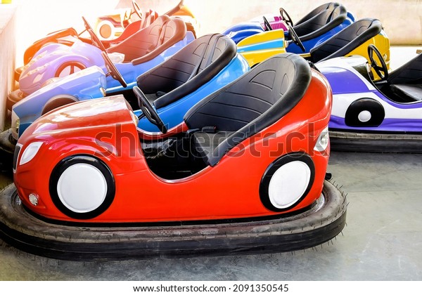 Children\'s attractions.\
Rows of Bump Cars. Colorful electric car for kids. Riding on Dodgem\
Cars. Close-up.