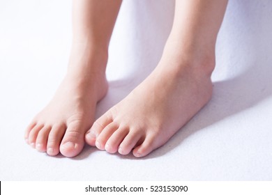 Children's bare feet. Child's bare feet on the wooden floor 