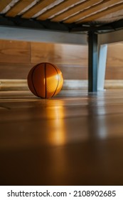 A Children's Basketball Under The Bed In The Sun.