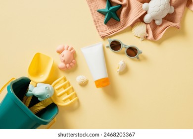 Childrens beach toys in bright colors, sunscreen lotion, stylish sunglasses, starfishes, assorted seashells on towel against a soft yellow backdrop. Perfect for illustrating family vacations. Flat lay - Powered by Shutterstock