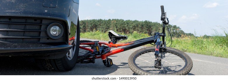 Children's bicycle accident with car on the street. Panoramic image