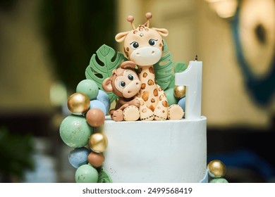 A children's birthday cake for a child in the jungle style. Decorating a cake in the form of animals - Powered by Shutterstock