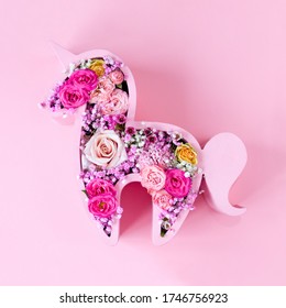 Children's Bouquet In The Form Of A Unicorn On A Pink Background. Creative Floristry. Flowers In Soft Pink Colors. The Picture In The Style Of Minimalism. 