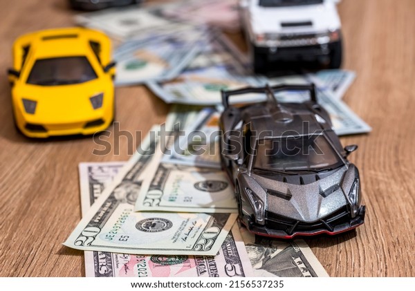 Children\'s car with dollars\
on the table