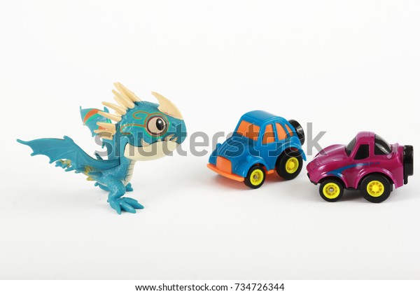 children\'s cars, little cars, colored cars,\
plastic, dragon on white\
background