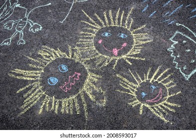 Children's chalk drawings on the asphalt - Powered by Shutterstock