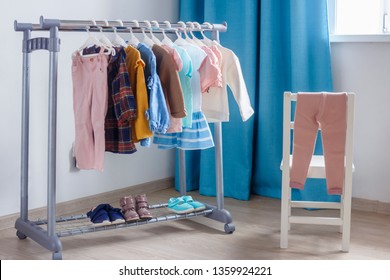 Children's cloth rack, selective focus. Pastel color children's  clothes in a Row on Open Hanger indoors. Clothes for little ladies hung in the children's room.
Turquoise and pastel pink colors. - Powered by Shutterstock