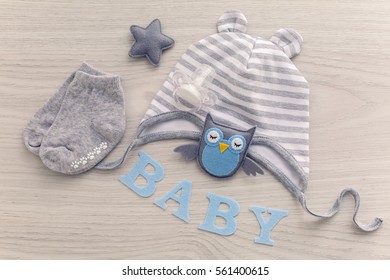 children's clothes with the diapers are stacked, and a toy bird owl - Powered by Shutterstock