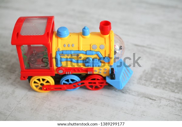 Children\'s colorful train on a background of\
white boards.