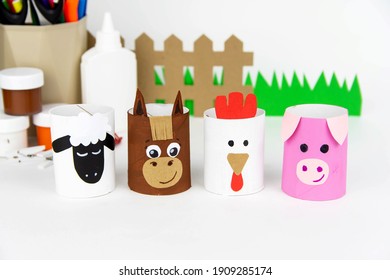 Children's Crafts Farm Pets From Toilet Sleeves. View From Above On Diy Of Farm Animals: Horse, Sheep, Scrolls, Rooster, Dog, Cat. Instruction Step By Step With The Child's Paper.