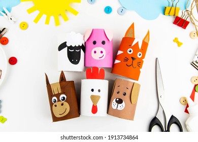 Children's Crafts Farm Pets From Toilet Sleeves. View From Above On Diy Of Farm Animals: Horse, Sheep, Scrolls, Rooster, Dog, Cat. Instruction Step By Step With The Child's Paper