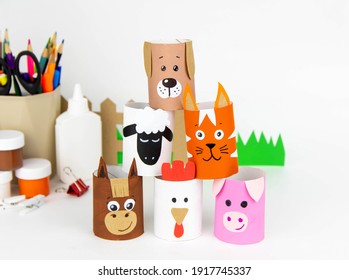 Children's Crafts Farm Pets From Toilet Sleeves. View From Above On Diy Of Farm Animals: Horse, Sheep, Scrolls, Rooster, Dog, Cat. Instruction Step By Step With The Child's Paper