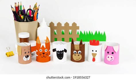 Children's Crafts Farm Pets From Toilet Sleeves. View From Above On Diy Of Farm Animals: Horse, Sheep, Scrolls, Rooster, Dog, Cat. Instruction Step By Step With The Child's Paper