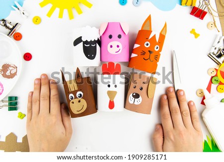 Children's crafts farm pets from toilet sleeves. View from above on diy of farm animals: horse, sheep, scrolls, rooster, dog, cat. Instruction step by step with the child's paper
