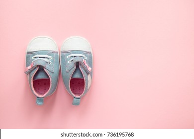 Children's denim sports shoes for girls, stands on a pink background. closeup view from the top. the concept of children's clothing.