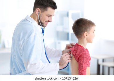 Children's doctor examining little boy in hospital