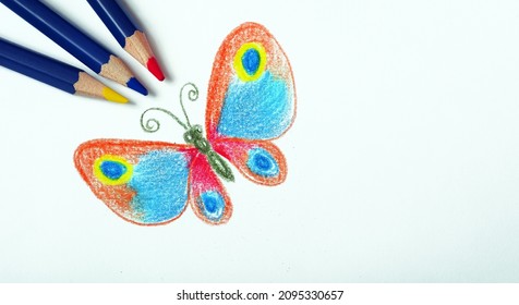 children's drawing with colored pencils. drawing of a bright tropical butterfly with pencils.