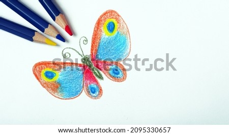 children's drawing with colored pencils. drawing of a bright tropical butterfly with pencils.