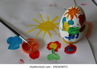  Children's drawing of Easter. Large Easter eggs were painted by small children, brushes and paints. The concept of children's creativity. - Powered by Shutterstock