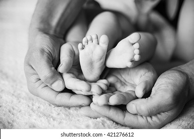 Children's feet in black white. The family