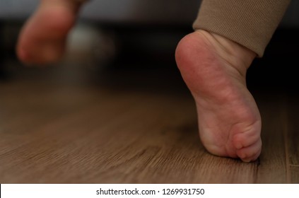children's feet near the sofa. baby's first steps - Shutterstock ID 1269931750