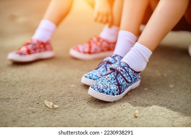 childrens feet in shoes close up.