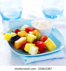 Children's Fruit Kabob With Vanilla Yogurt Dip On Blue Plate