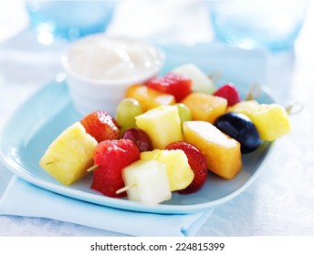 Children's Fruit Kabob With Vanilla Yogurt Dip On Blue Plate