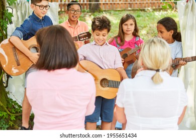 Children's Group With Guitars At The Talent Show At The Holiday Camp Or At The Summer Camp