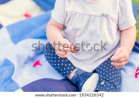 
Children's hand in the hands of the mother. A tiny child's hand on a close-up of female hands. Mom and her child. Happy family concept. Beautiful conceptual image of motherhood