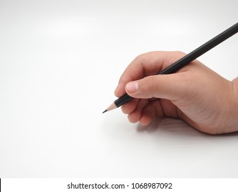 Children's hand holding pencil