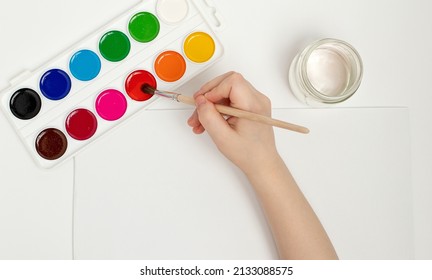 Children's Hands Begin To Draw At A Table With Art Supplies, Top View