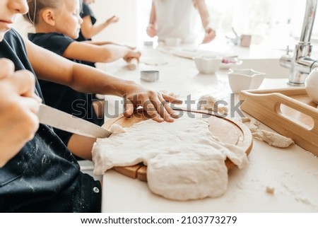 Childrens hands with dough close-up. Family cook.