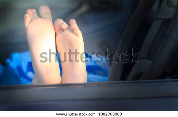 children\'s hands and feet. blue car. concept travel\
by car.