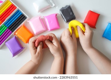 Children's hands modeling plasticine, top view, concept of creativity and education. - Shutterstock ID 2283963551