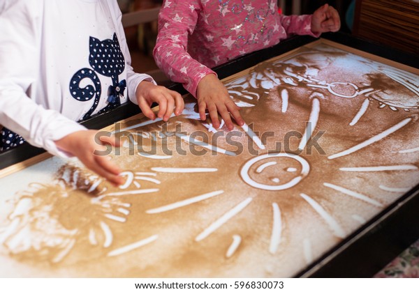 Children\'s hands on the\
sand, sand animation