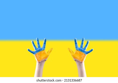 Children's Hands Are Painted In The Colors Of The Ukrainian Flag Reaching Up Against The Background Of The Ukrainian Flag. Request For Help. Please Stop The War. No War.