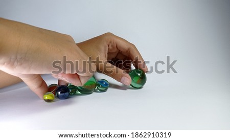 children's hands play marbles. suitable for design elements on the theme of games, education, home activities, and recreation