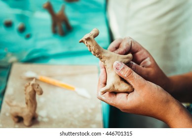 children's hands sculpts clay crafts pottery school. Horse of clay - Powered by Shutterstock