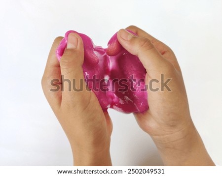 children's hands squeezing or playing with very fun and cute elastic slime on an isolated white background. Children playing with slime