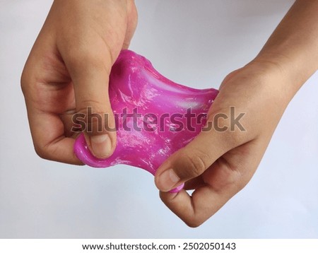 children's hands squeezing or playing with very fun and cute elastic slime on an isolated white background. Children playing with slime