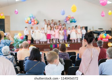 Children's Holiday In Kindergarten. Children On Stage Perform In Front Of Parents. Image Of Blur Kid 's Show On Stage At School , For Background Usage. Blurry