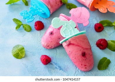 Children's Ice Cream Popsicles (rasberry Sorbet) On Blue Concrete Background.