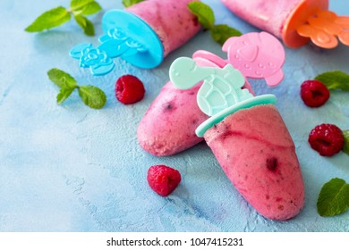 Children's Ice Cream Popsicles (rasberry Sorbet) On Blue Concrete Background. Copy Space.