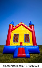 Children's Inflatable Bouncy Castle House In A Yard.