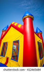 Children's inflatable bouncy castle in red, yellow and blue - Shutterstock ID 412465684