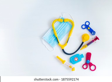 Children's Medical Instruments. Children's Doctor Concept. Pediatrics. Toy Medical Devices On A White Background. Covid-19 Is Not A Game. Go, Get Vaccinated Concept. High Quality Photo