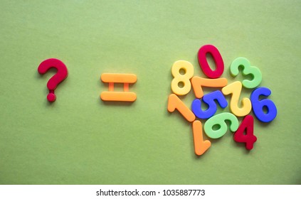 children's multi-colored numbers on a green background, copy space