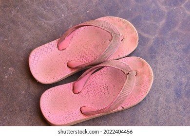 Children's Old Sandals On The Floor